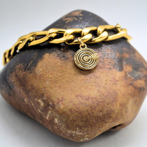 Chunky gold chain bracelet with a heart and bullseye charm
