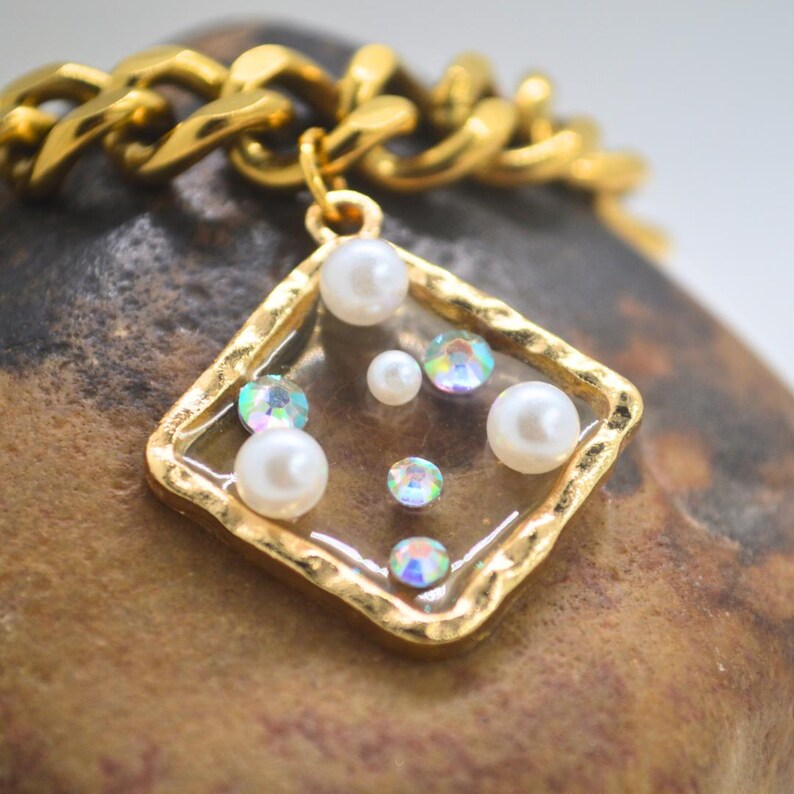 Square pendant filled with pearls and rhinestones
