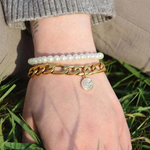 Chunky gold chain bracelet with a heart and bullseye charm