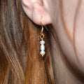 Gold hook earrings with three white faux pearls