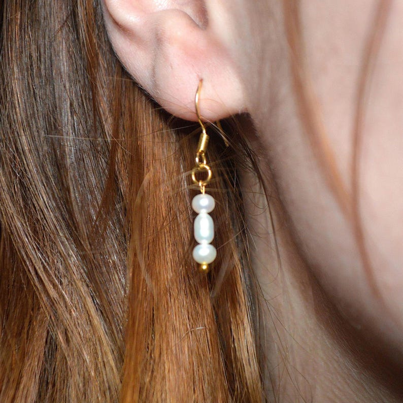 Gold hook earrings with three white faux pearls