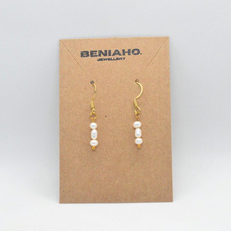 Gold hook earrings with three white faux pearls