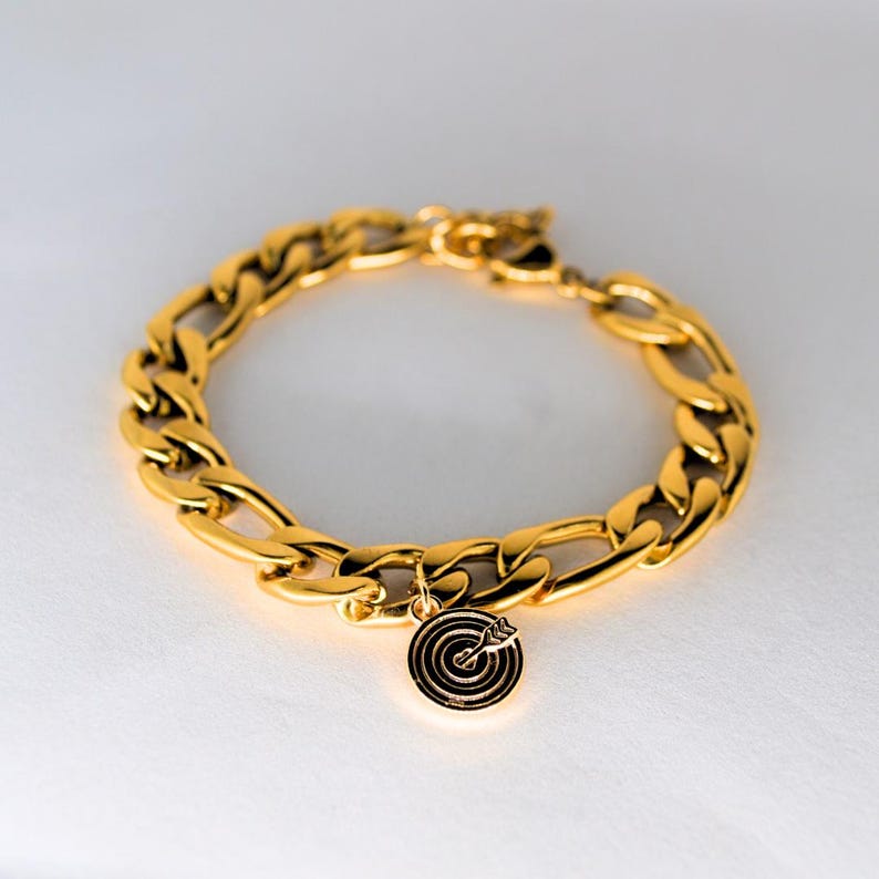 Chunky gold chain bracelet with a heart and bullseye charm