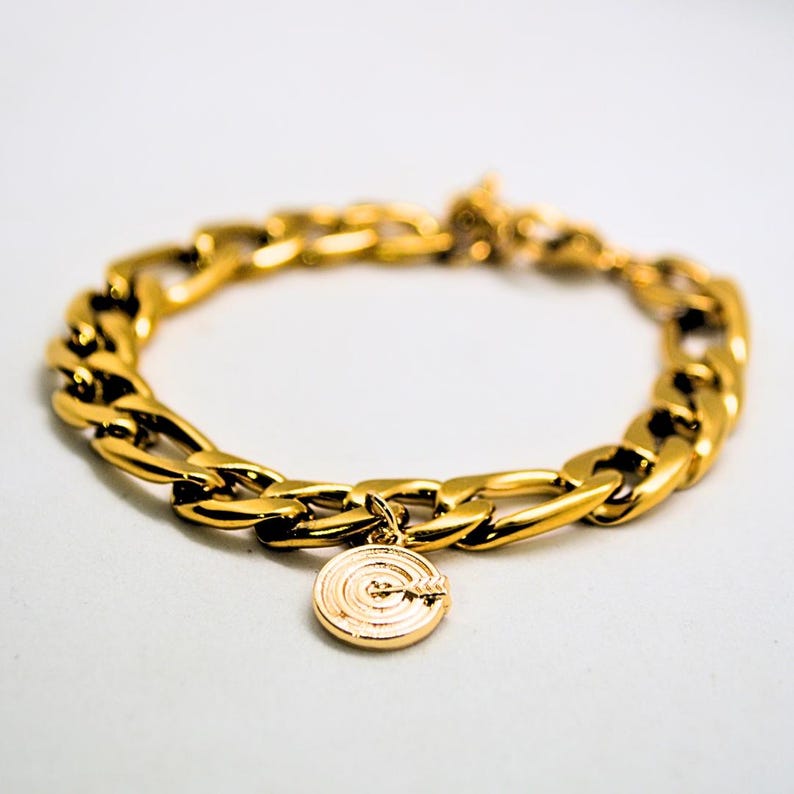 Chunky gold chain bracelet with a charm