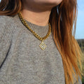 Gold chunky necklace with a square pearl and gem pendant