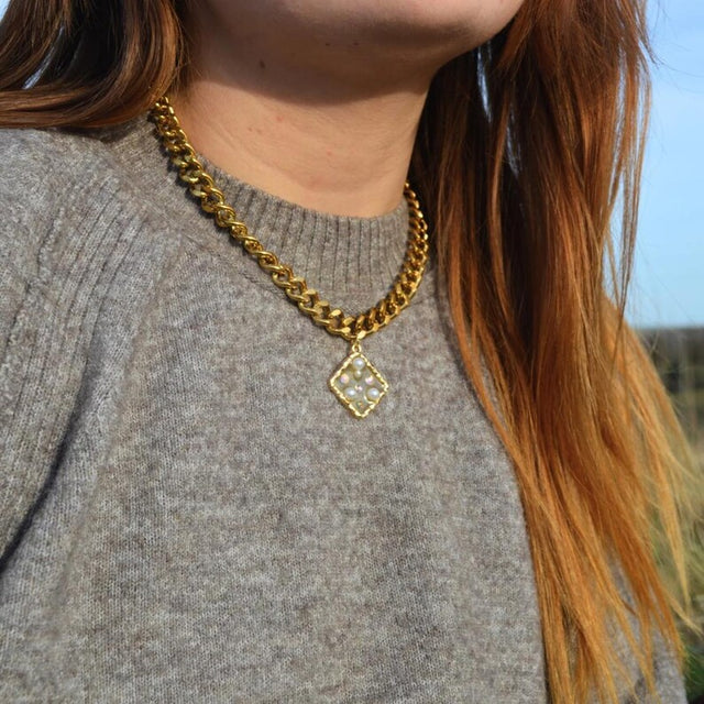 Gold chunky necklace with a square pearl and gem pendant