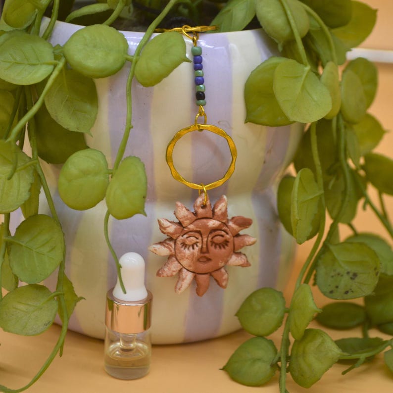 Terracotta air dry clay sun pendant with gold rings and blue beads