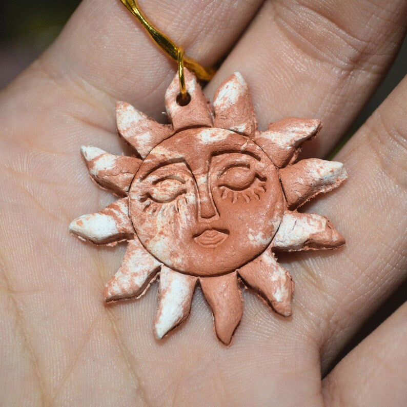 Terracotta clay sun pendant close up