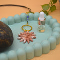 Terracotta air dry clay sun pendant with gold rings and blue beads