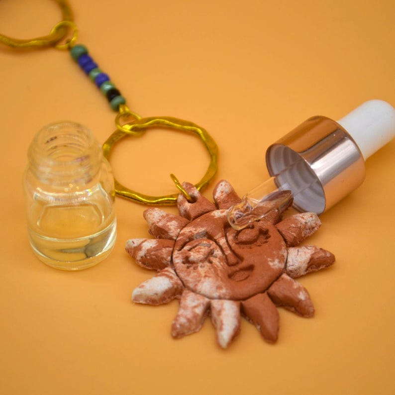 Sun pendant with a glass dropper bottle