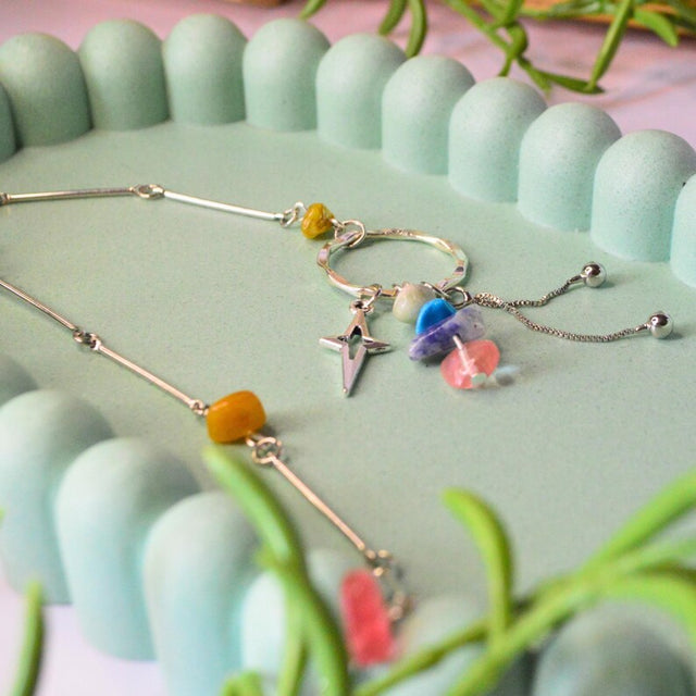 Multicoloured stone beaded necklace with three dangling charms